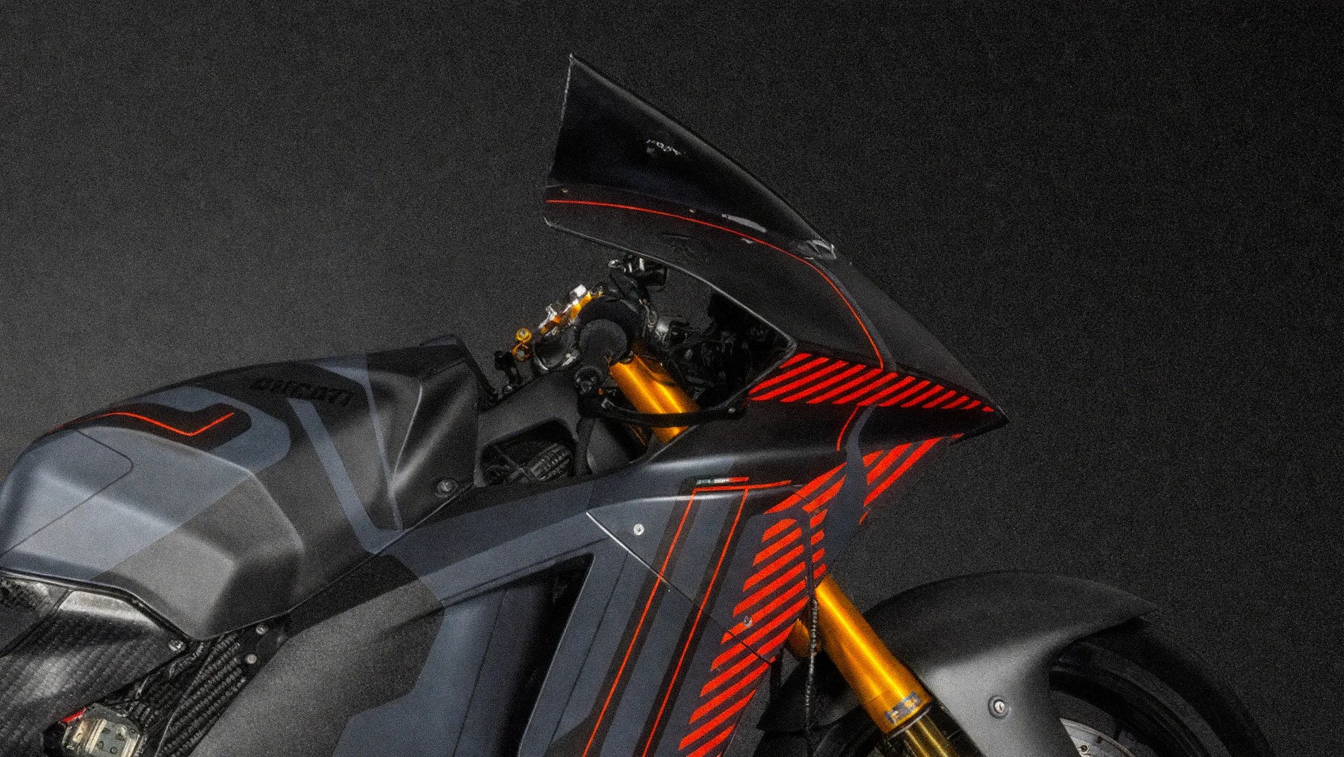 Close-up of a black Ducati motorcycle front with red stripes and gold front suspension forks.