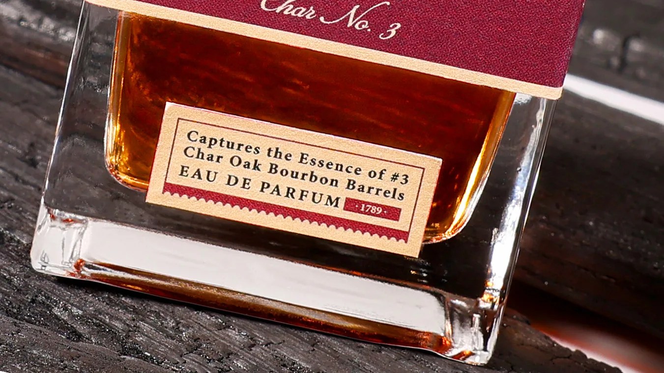 Close-up of a perfume bottle label reading "Captures the Essence of #3 Char Oak Bourbon Barrels EAU DE PARFUM.