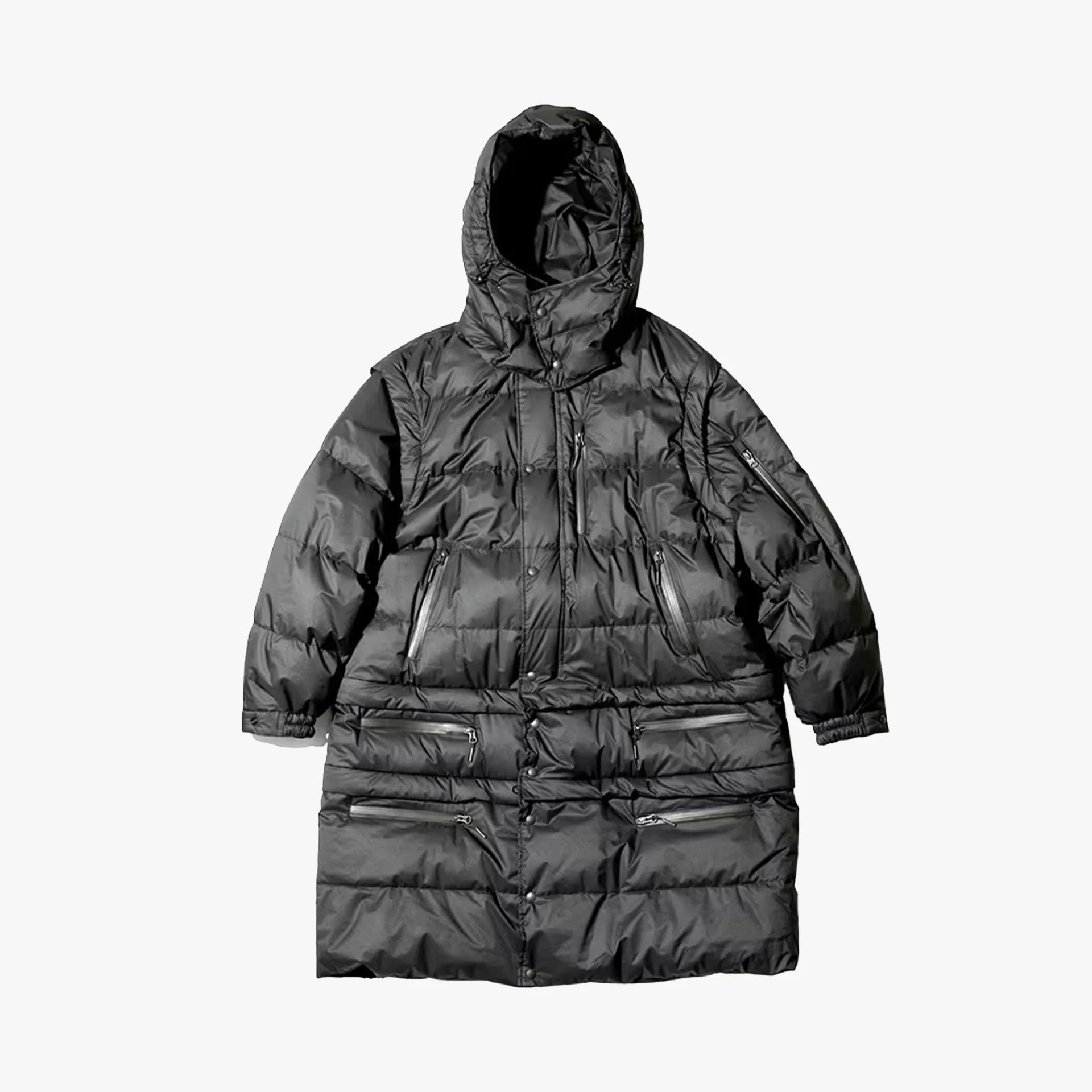 Long black puffer coat with hood and multiple zippered pockets laid flat.