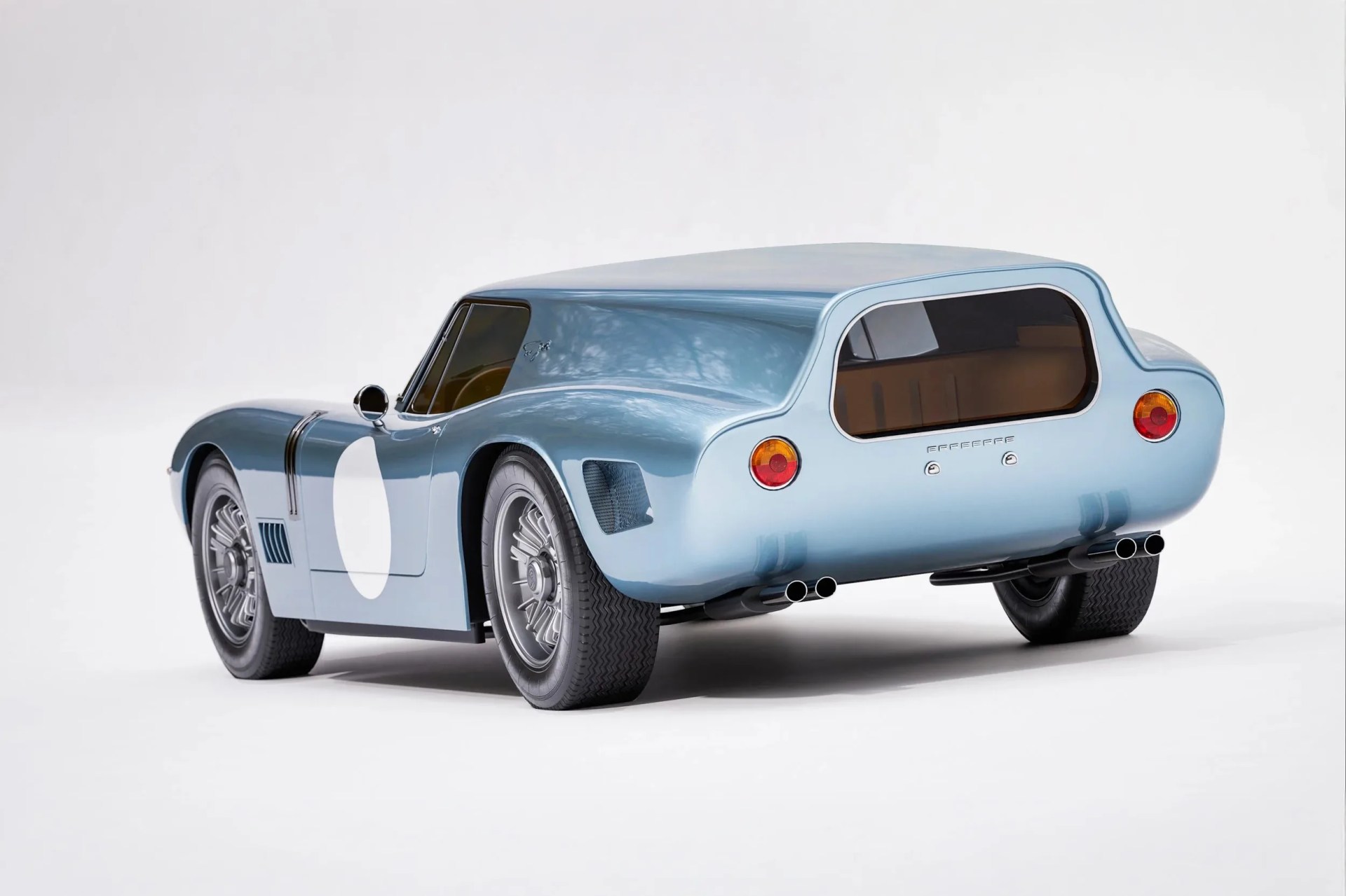 Light blue vintage race car with rounded rear and dual exhaust pipes on each side.