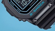 Close-up of a black Casio G-Shock digital watch with blue accents on a blue background.