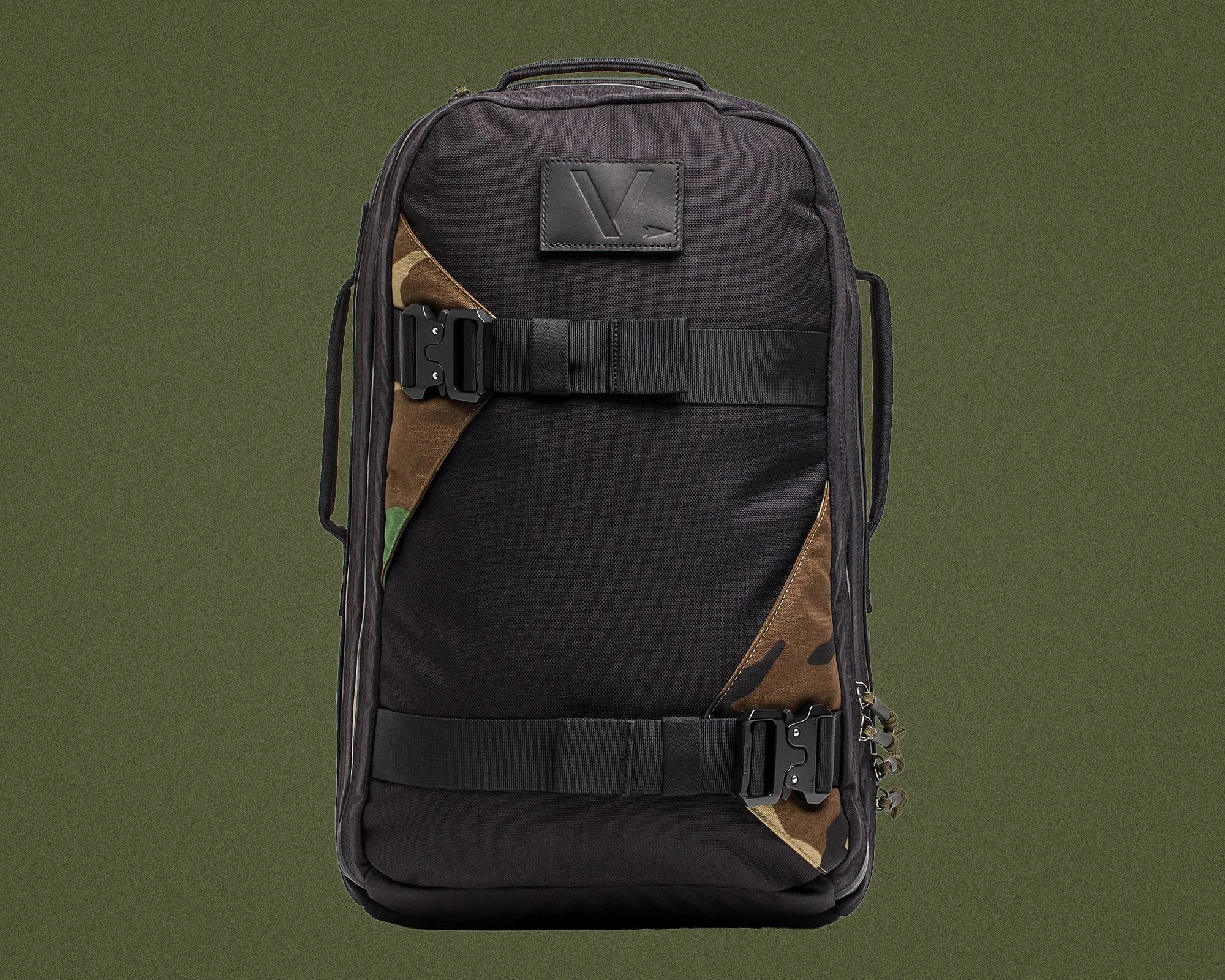 Black rectangular backpack with camouflage corner accents, two black buckle straps, and a top handle.