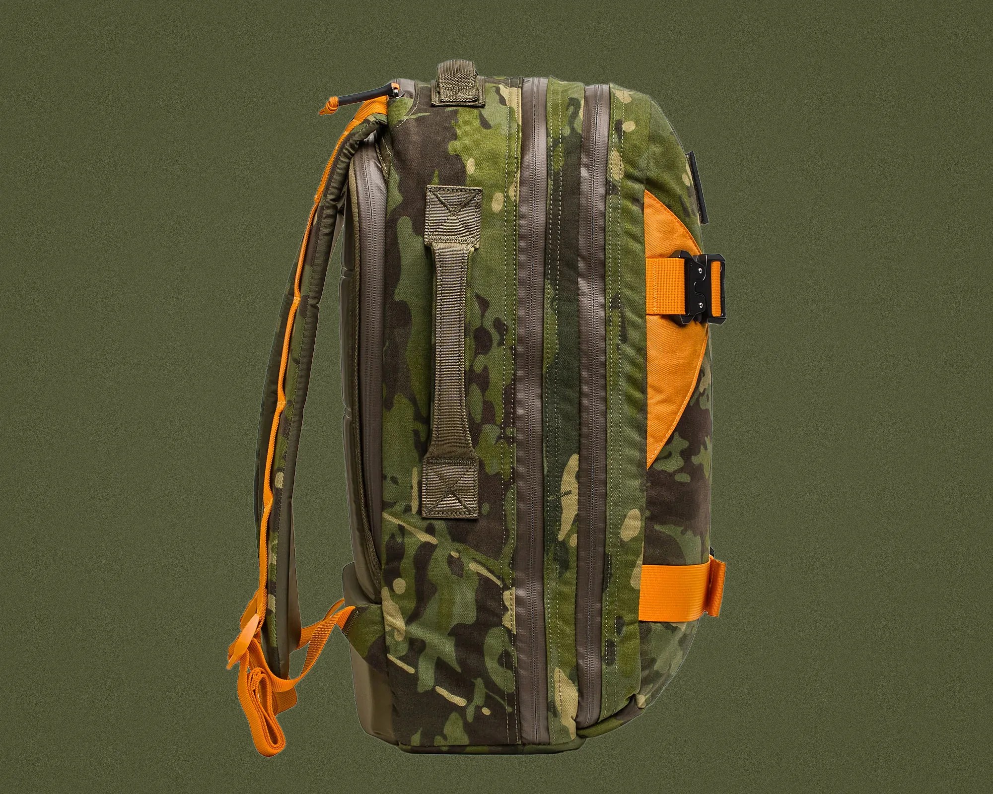 Camouflage backpack with orange straps and accents shown from the side against an olive green background.