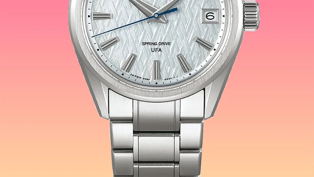 Silver metal wristwatch with textured white dial, blue second hand, date window, and linked bracelet band.