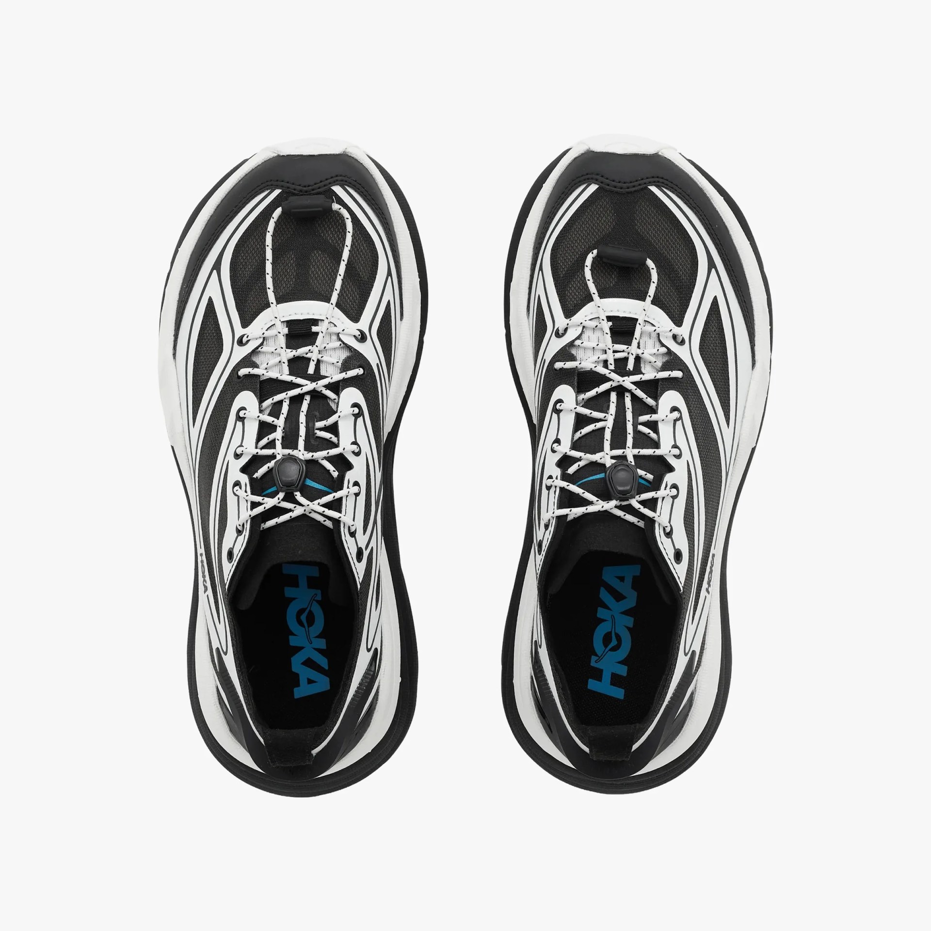 Pair of black and white Hoka running shoes with patterned laces viewed from above.