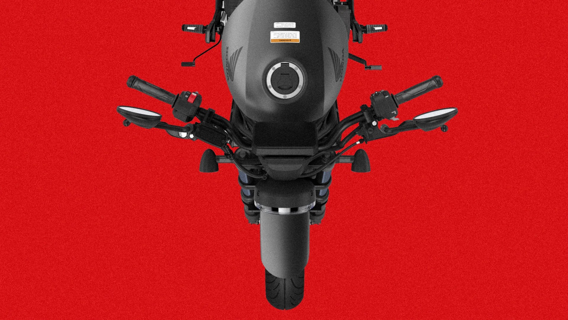 Top-down view of a matte black Honda motorcycle against a red background.