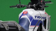 Close-up of a white Honda Transalp SP motorcycle fuel tank and handlebars with blue and red graphics.