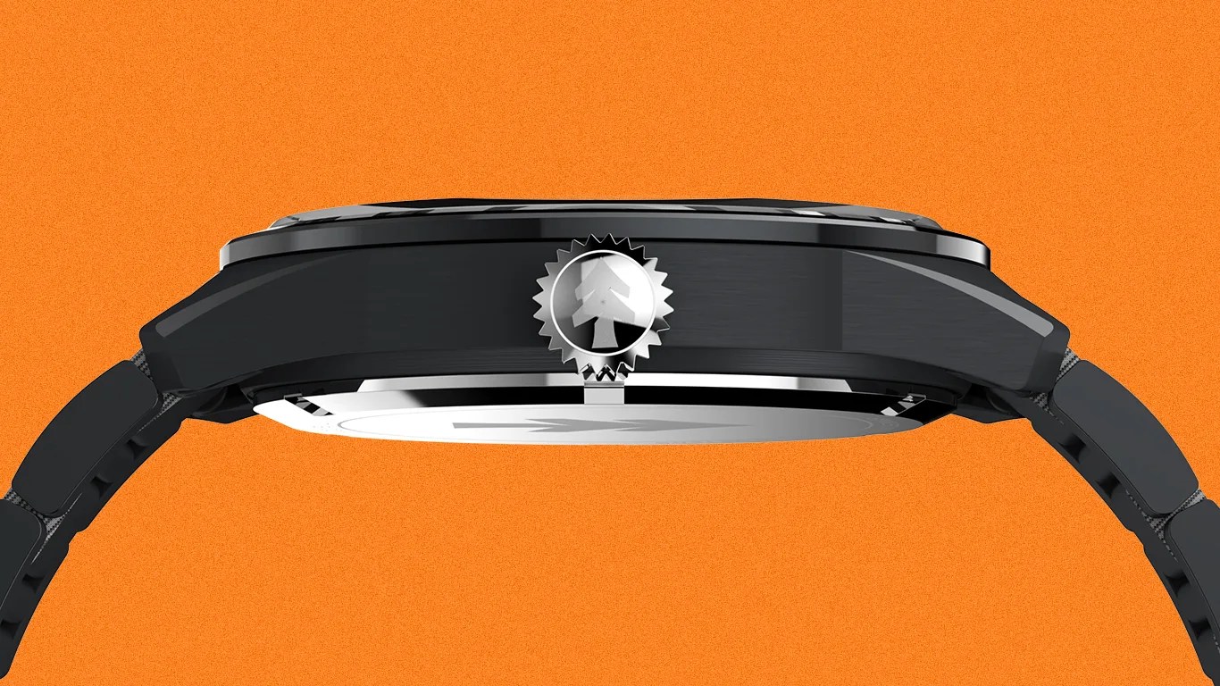 Side view of a black wristwatch with a textured crown featuring a tree emblem against an orange background.
