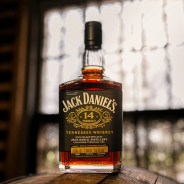 Bottle of Jack Daniel's 14-year-old Tennessee whiskey with black label and gold lettering on wooden surface.