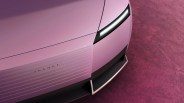Close-up of the front end of a pink Jaguar car with sleek LED headlight and horizontal grille lines.