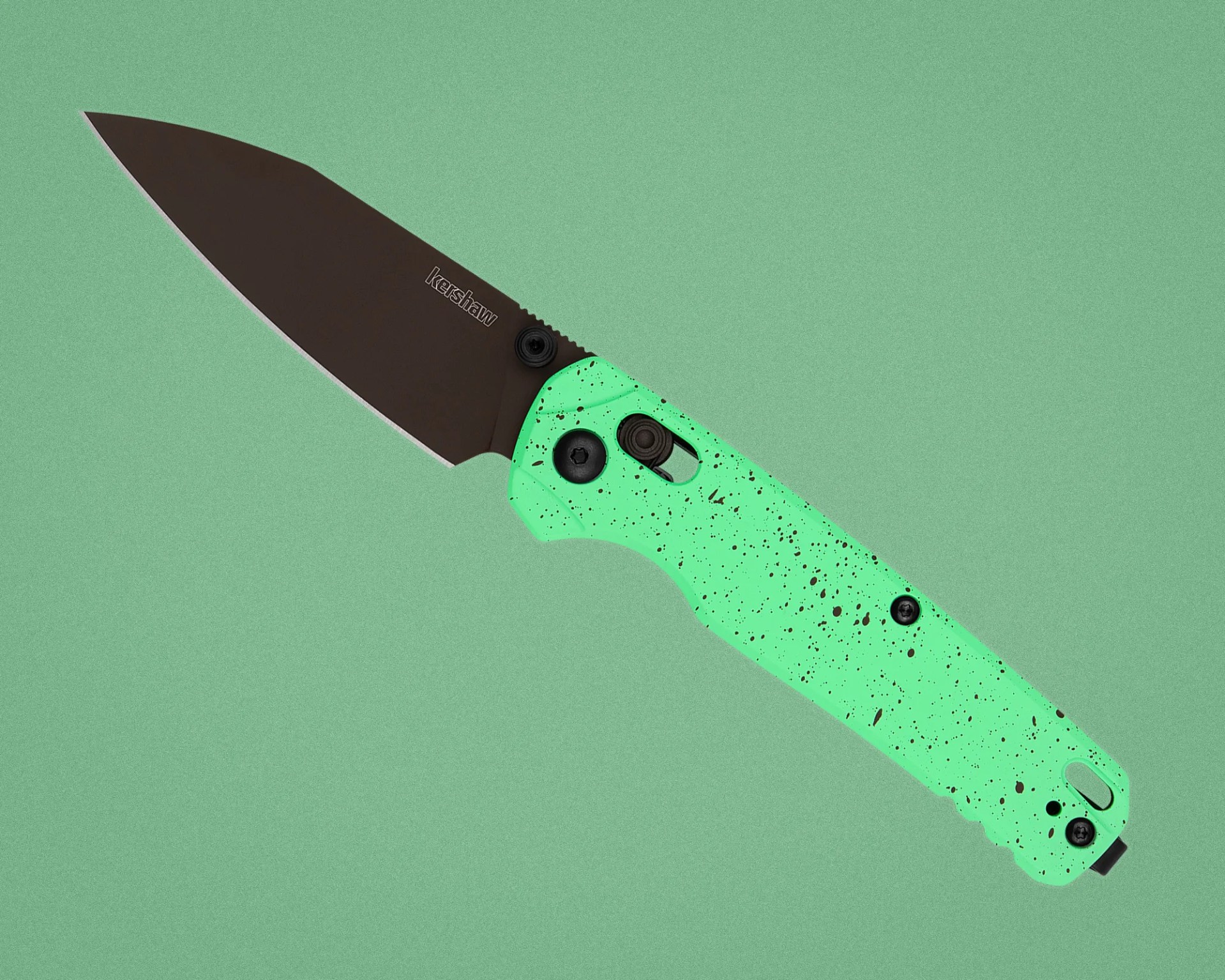 Folding knife with a black blade and a mint green handle speckled with black dots.