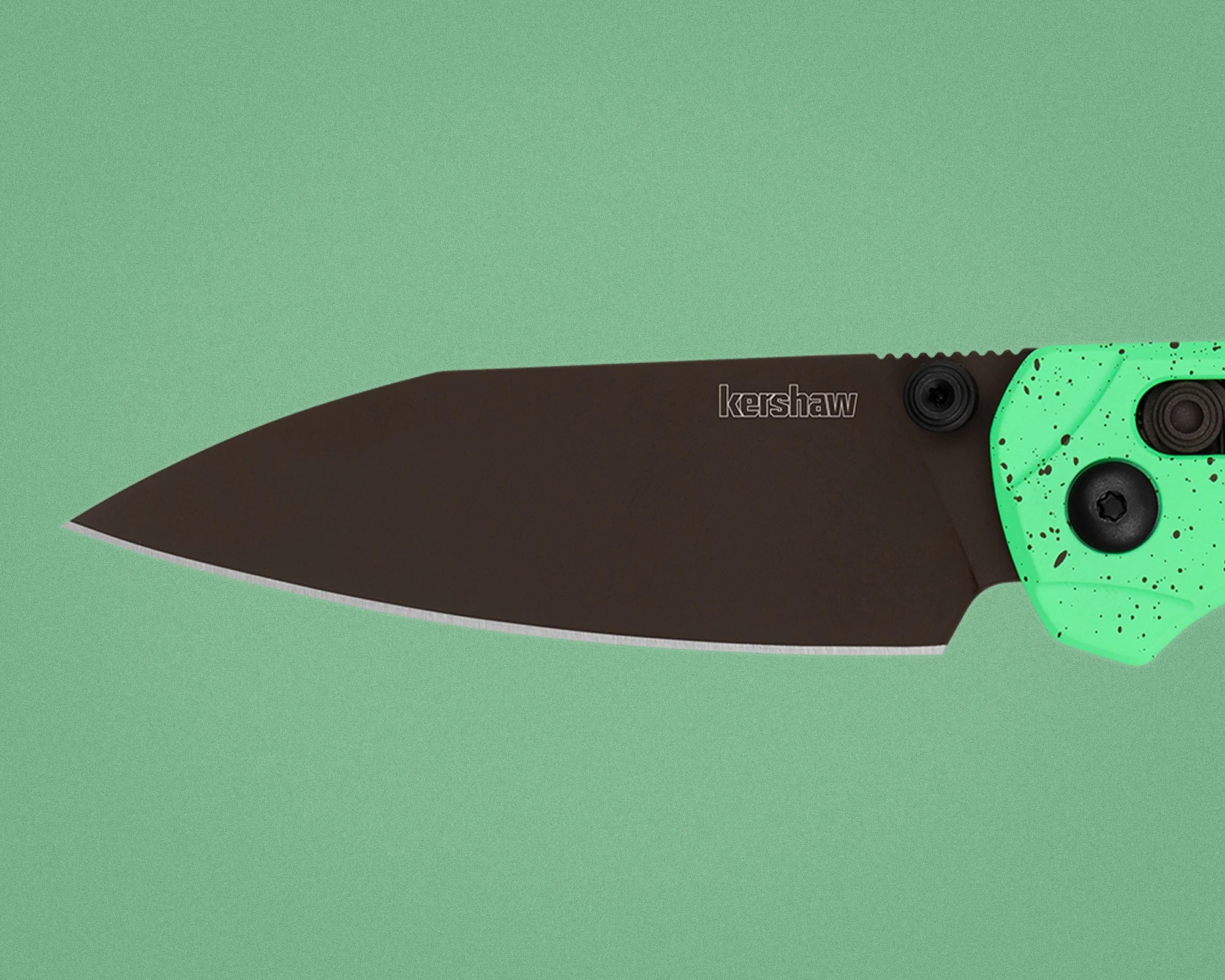 Black Kershaw folding knife blade with a mint green handle speckled with black dots.