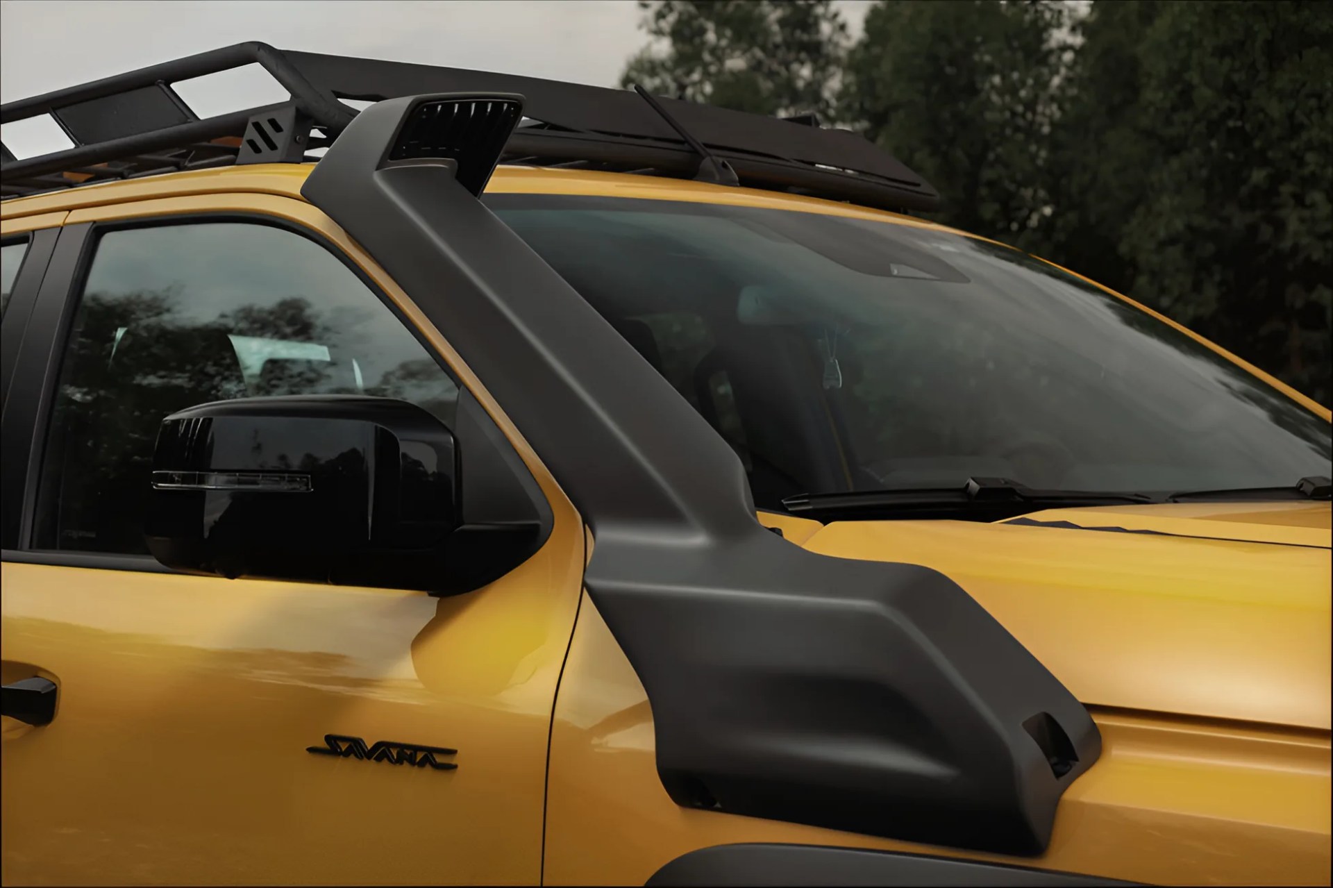 Yellow SUV with a black snorkel air intake attached to the passenger side near the windshield.