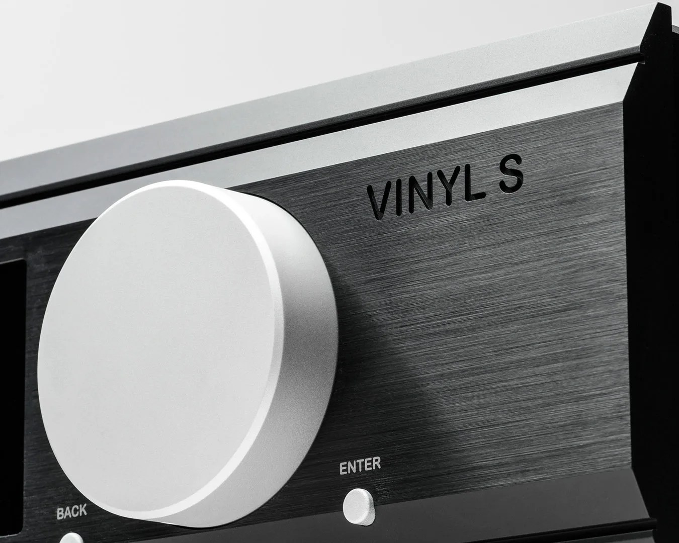 Close-up of a silver control knob on a black brushed metal panel labeled "VINYL S" with small buttons labeled "BACK" and "ENTER.