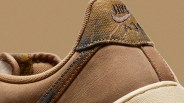 Close-up of the heel area of a tan Nike Air sneaker with textured fabric and suede materials.