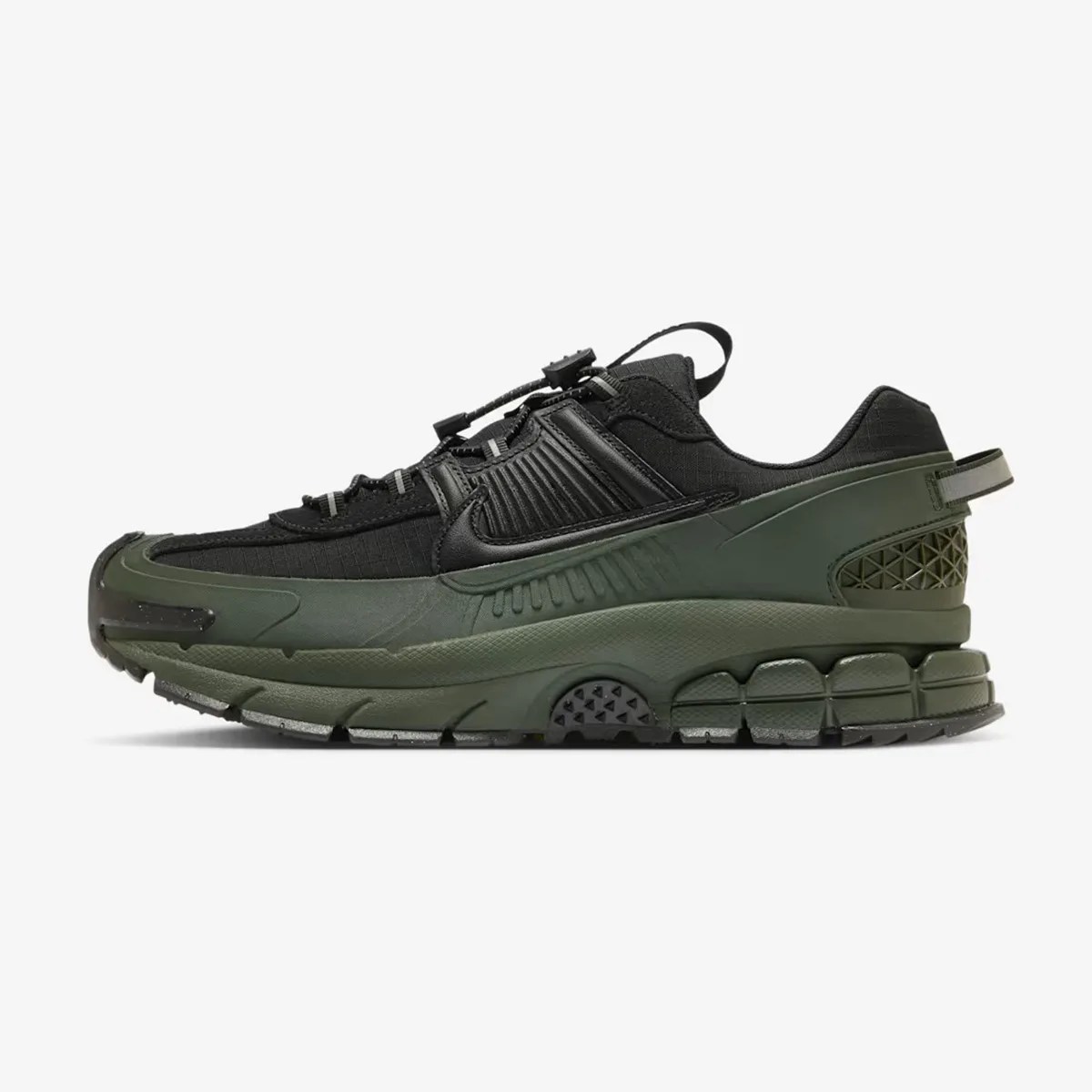Black and dark green Nike sneaker with textured sole and pull tab at the heel.
