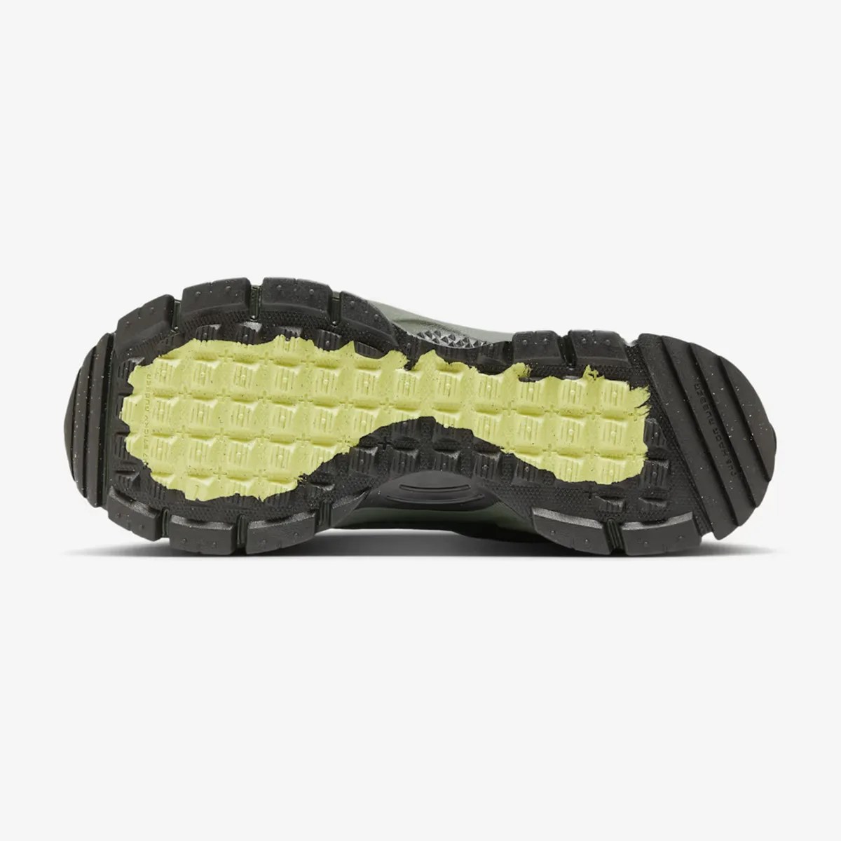 Black and yellow textured rubber outsole of a trail running shoe with deep treads.