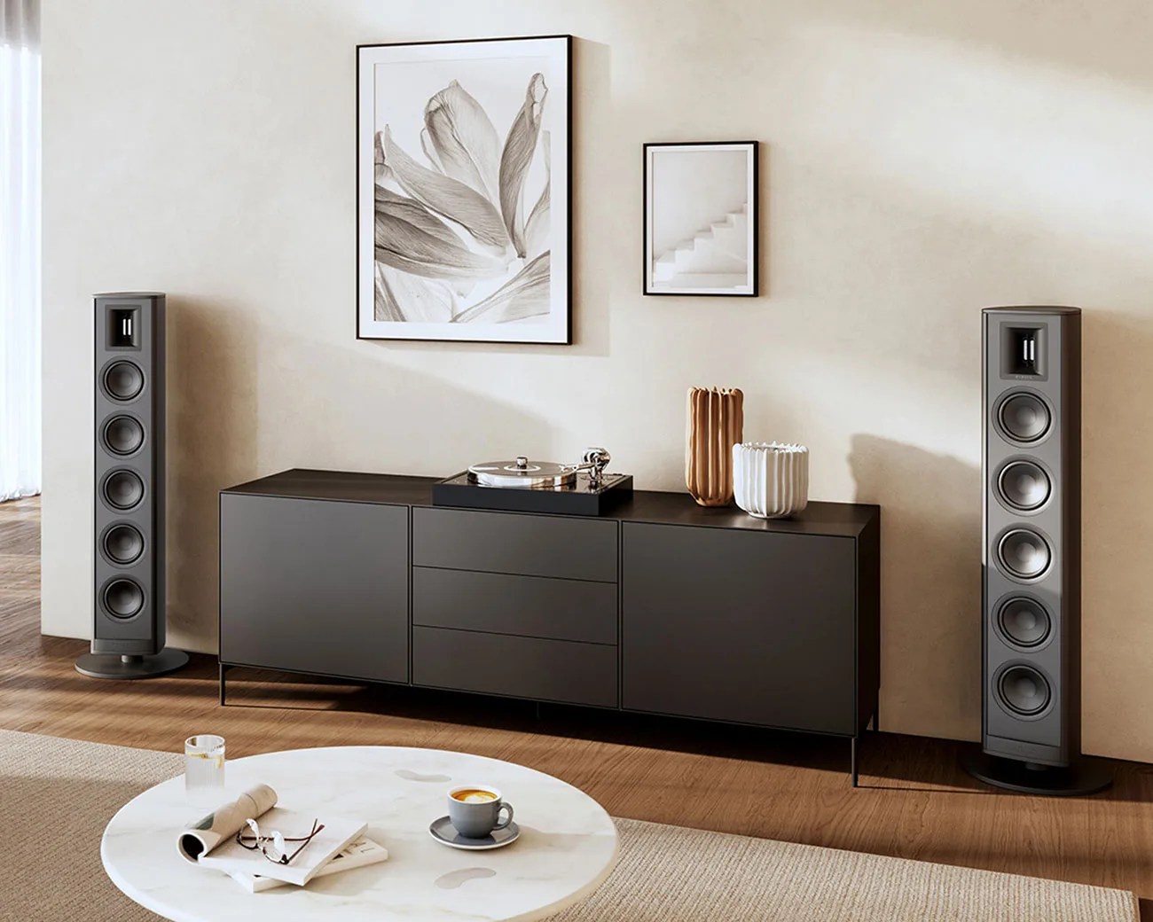 Black modern sideboard with a turntable and decorative vases, flanked by two tall gray floor-standing speakers.