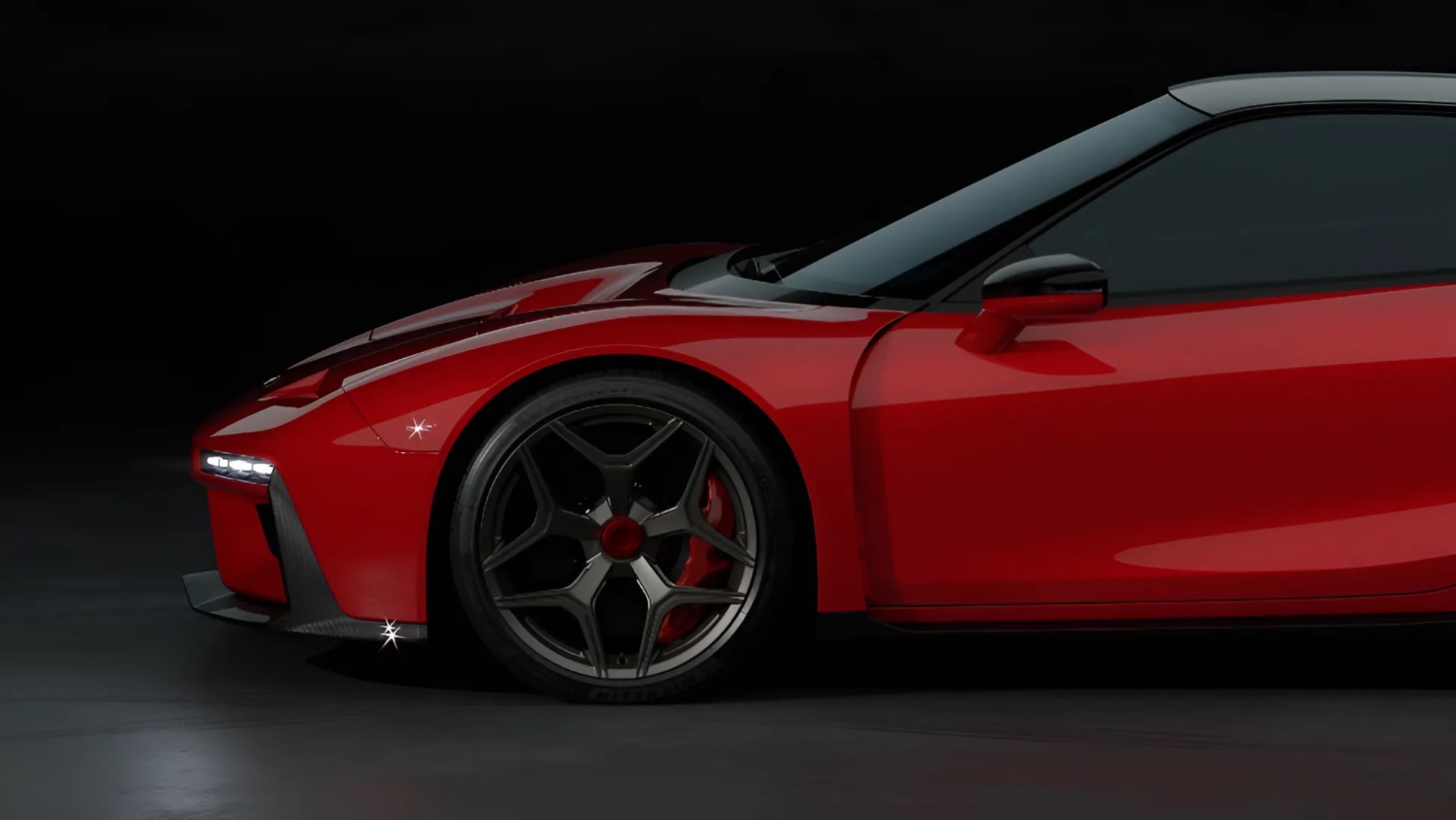 Close-up of the front side of a red sports car with black and red alloy wheel and black side mirror against a dark background.