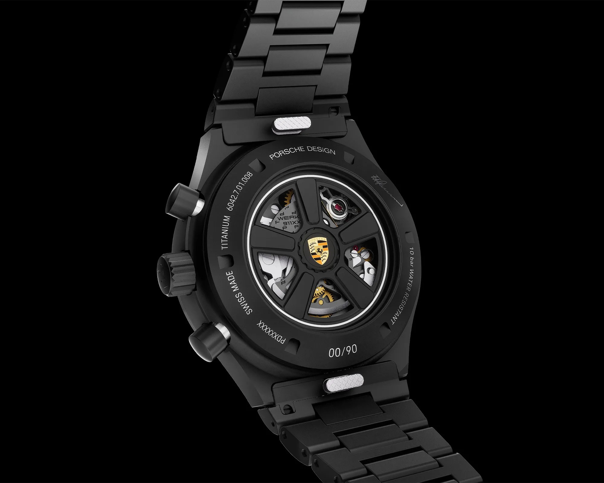 Back of a black Porsche Design titanium wristwatch showing mechanical movement through a transparent case back with black metal bracelet.