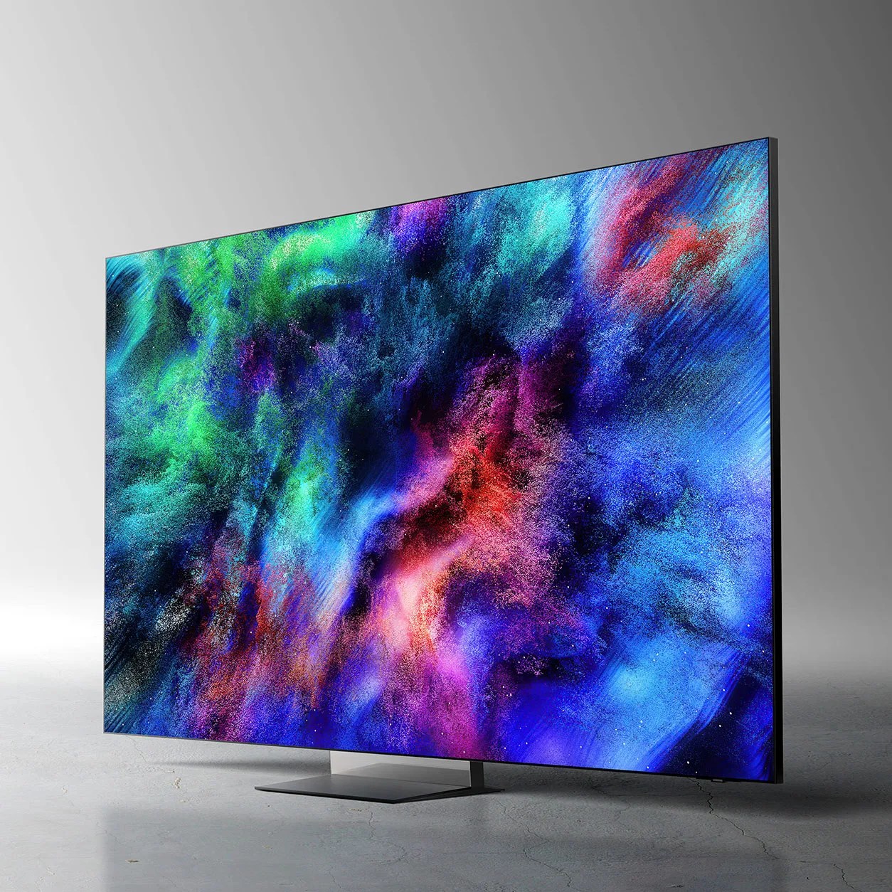 Slim flat-screen TV with vibrant abstract colorful display on a gray surface.