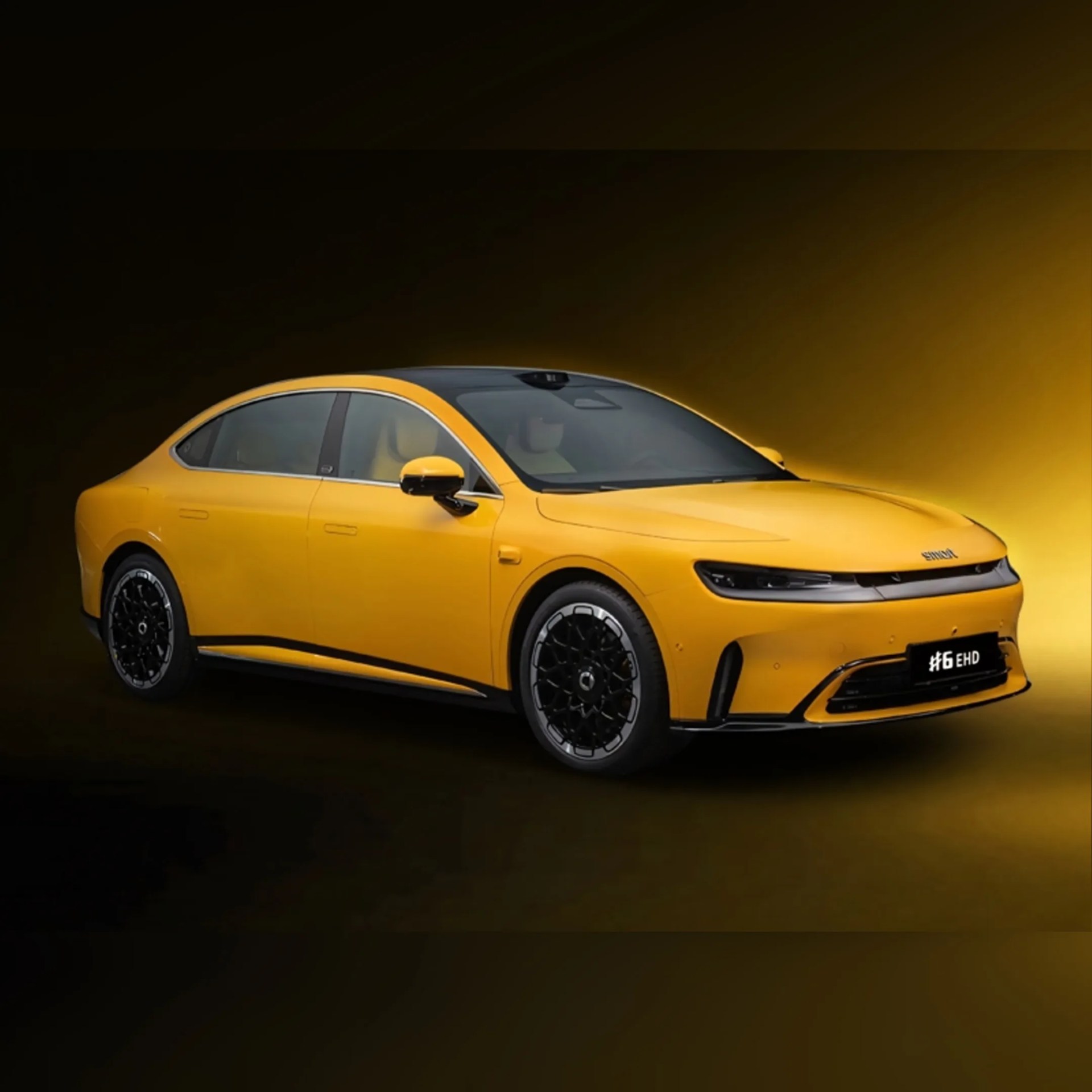 Yellow electric sedan with black roof and intricate black alloy wheels on a dark yellow gradient background.