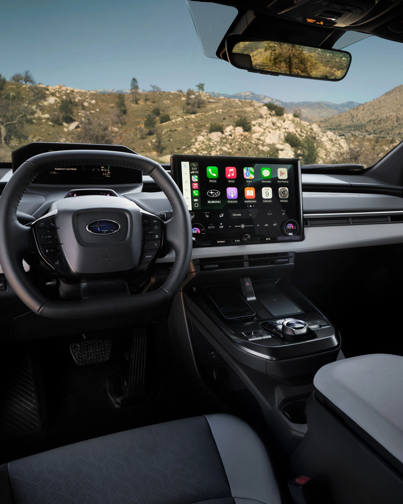 Black and gray Subaru car interior with digital dashboard and touchscreen infotainment system showing apps.