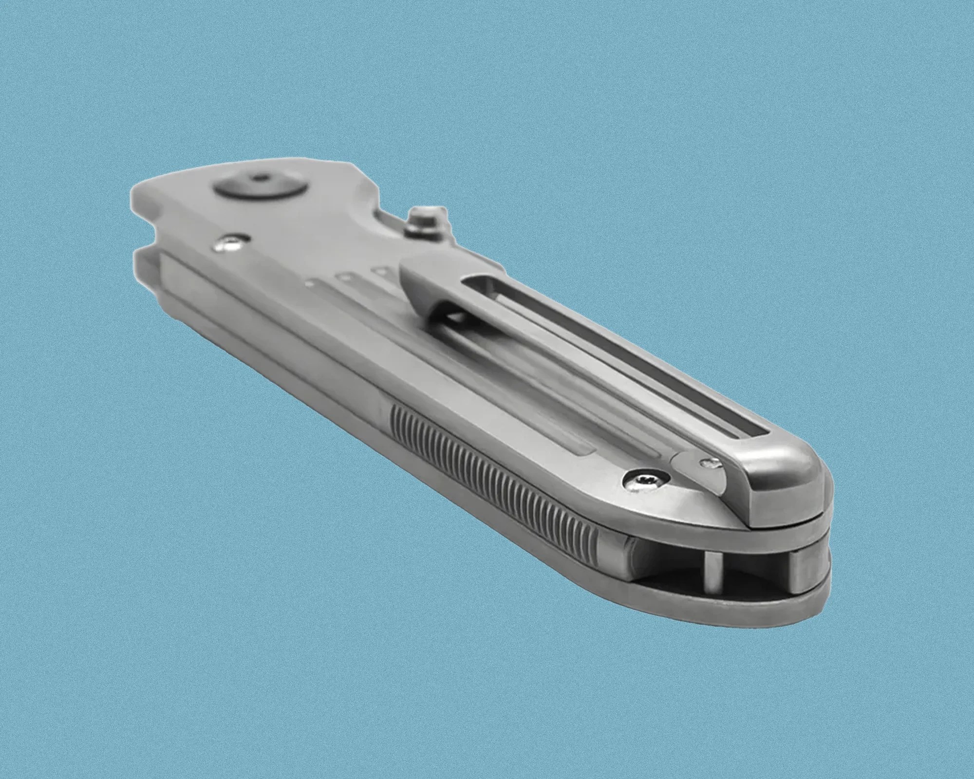 Closed silver metal folding knife with a pocket clip on a blue background.