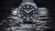 Timex Deepwater dive watch with blue bezel and dial partially submerged in water.
