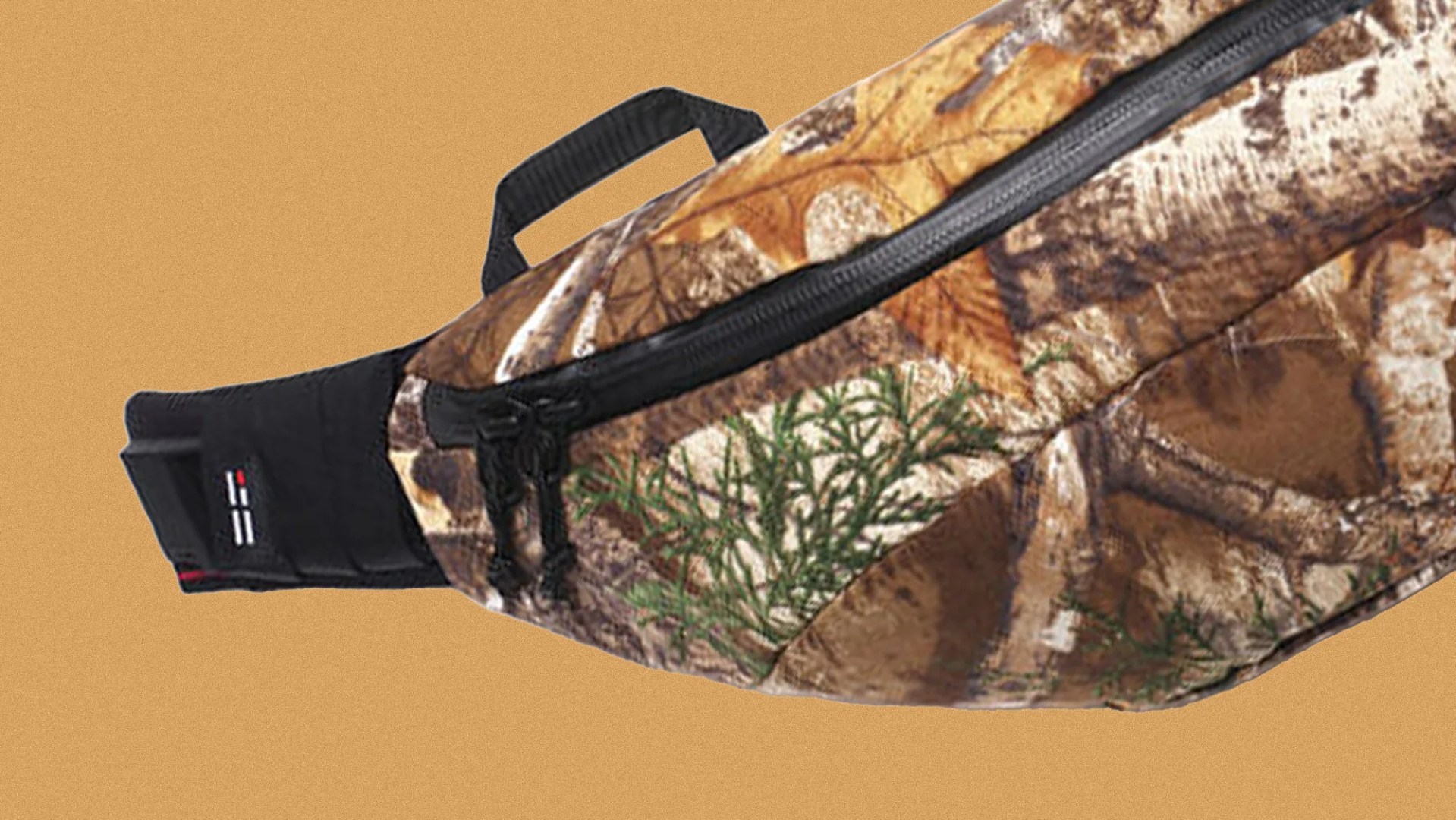 Camouflage-patterned waist bag with black zipper and handle on a tan background.