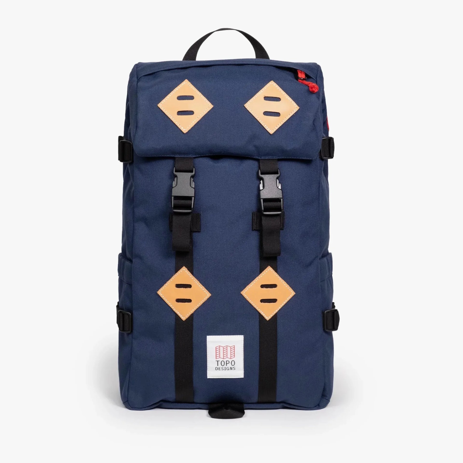 Navy blue Topo Designs backpack with black straps and tan leather diamond patches.