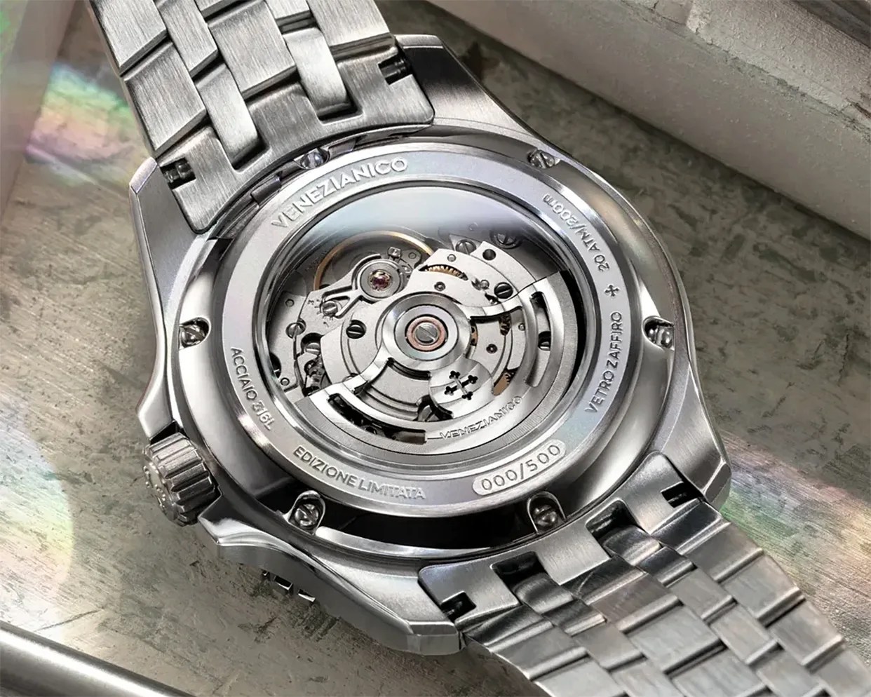 Back of a stainless steel automatic wristwatch with visible movement and engravings including "Venezianico," "Edizione Limitata," and "000/500.