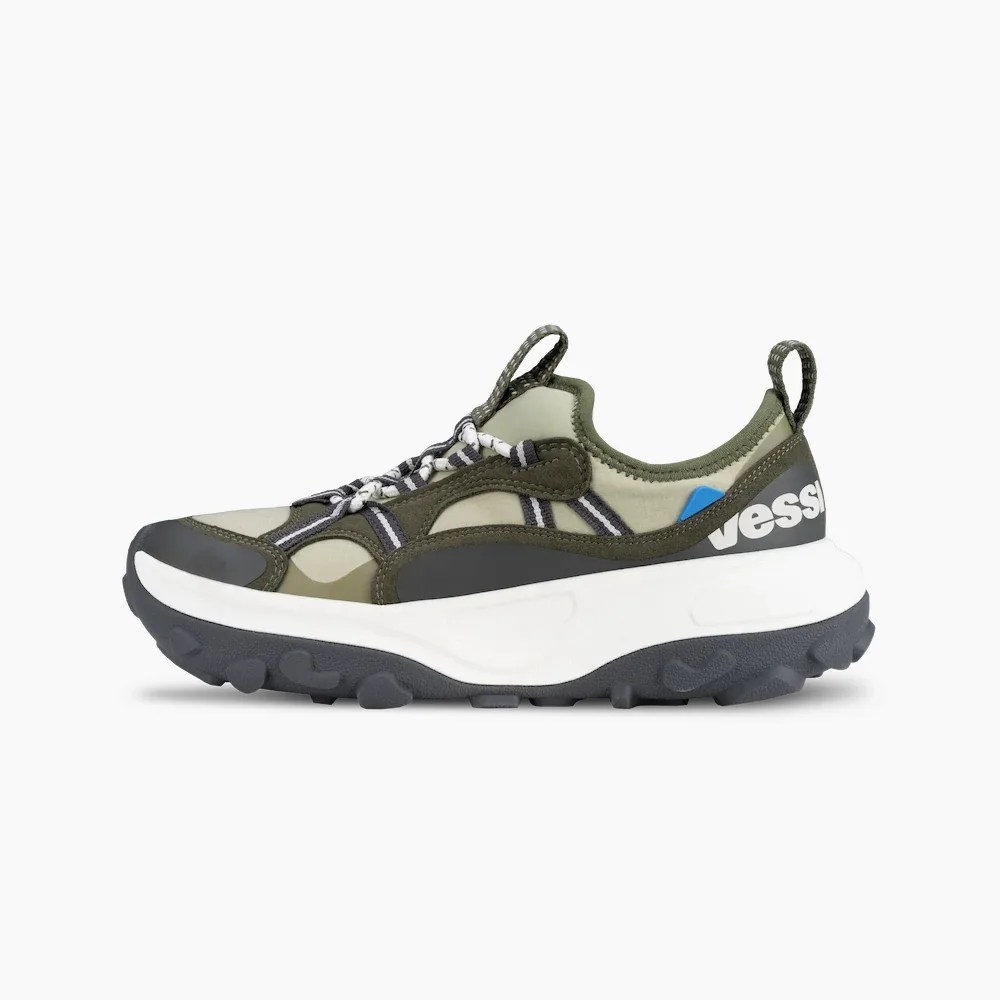 Olive green and black sneaker with white chunky sole and "vessi" branding on the heel.