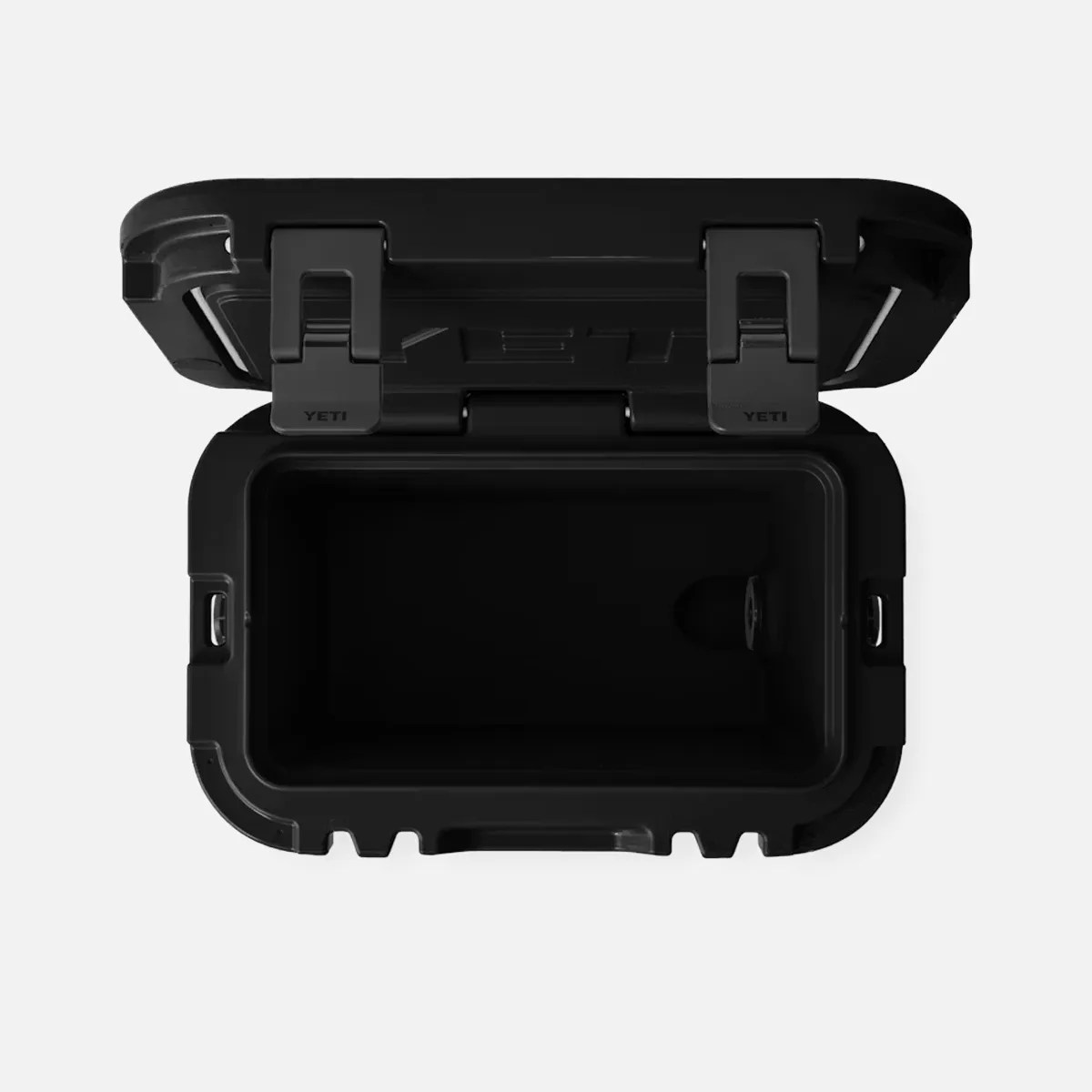 Black YETI cooler with lid open, showing empty interior and two latches on the front.