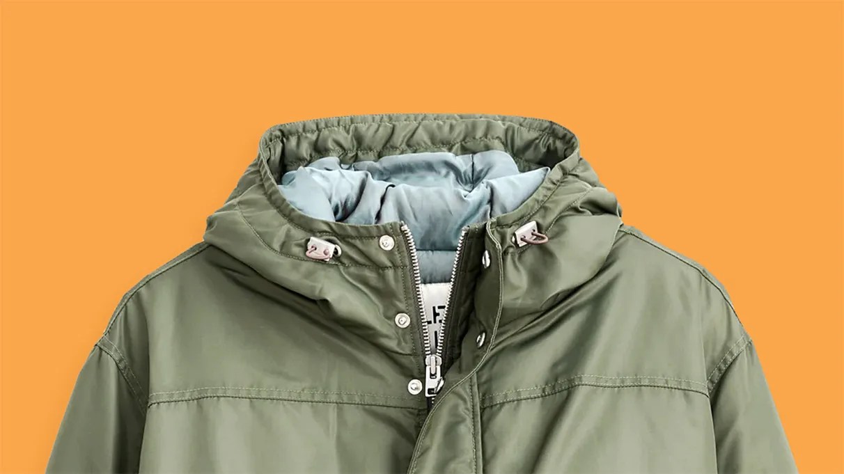 Olive-green hooded jacket with zipper and snap buttons on an orange background.