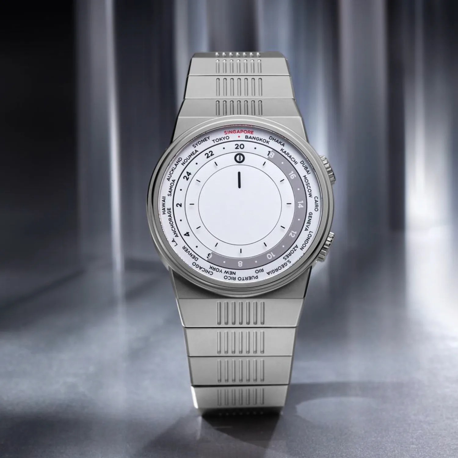 Silver metal wristwatch with a white dial featuring world city names and a 24-hour time display.