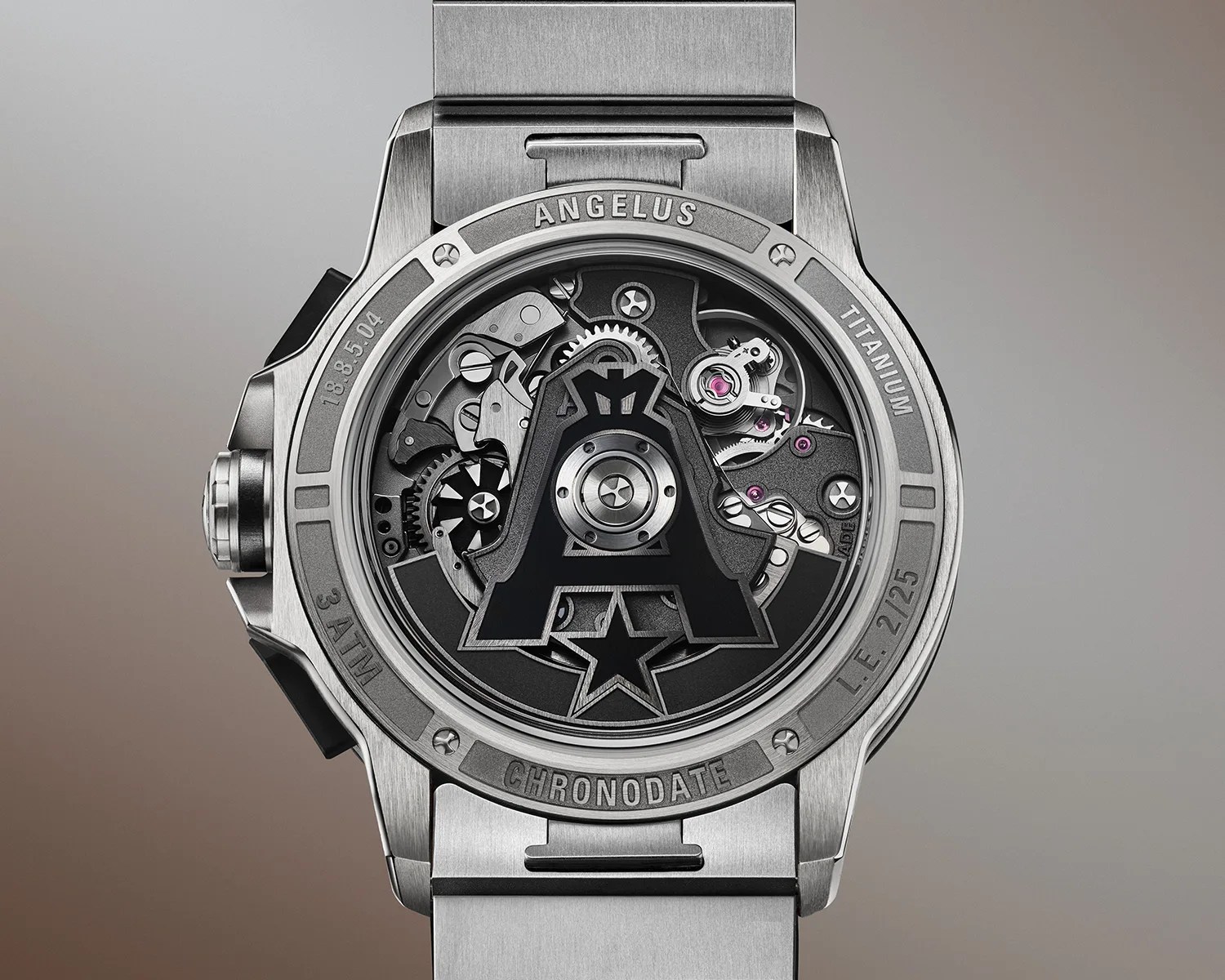 Back of a titanium Angelus Chronodate watch showing mechanical movement with a large black "A" and star design.