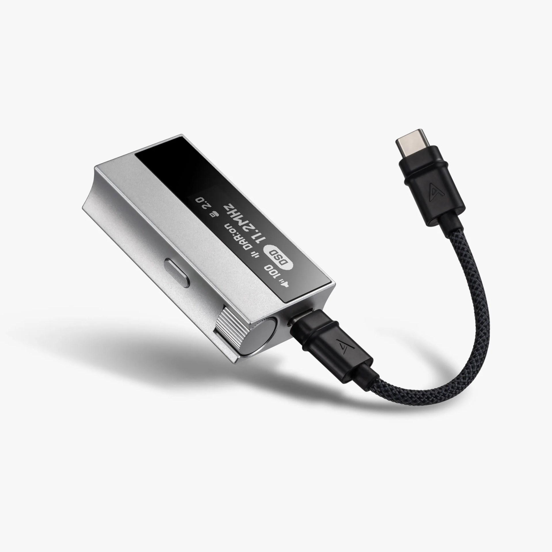 Silver digital audio player with black braided USB-C cable attached on a white background.