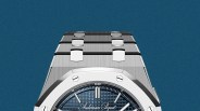 Silver stainless steel Audemars Piguet watch with blue textured dial and metal bracelet.