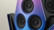 Close-up of a speaker panel with three black drivers set in a gradient purple-to-blue metallic frame.