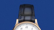 Rose gold watch with white dial and black leather strap on a blue background.