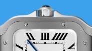 Close-up of a silver watch face with black Roman numerals and a blue hand against a blue background.