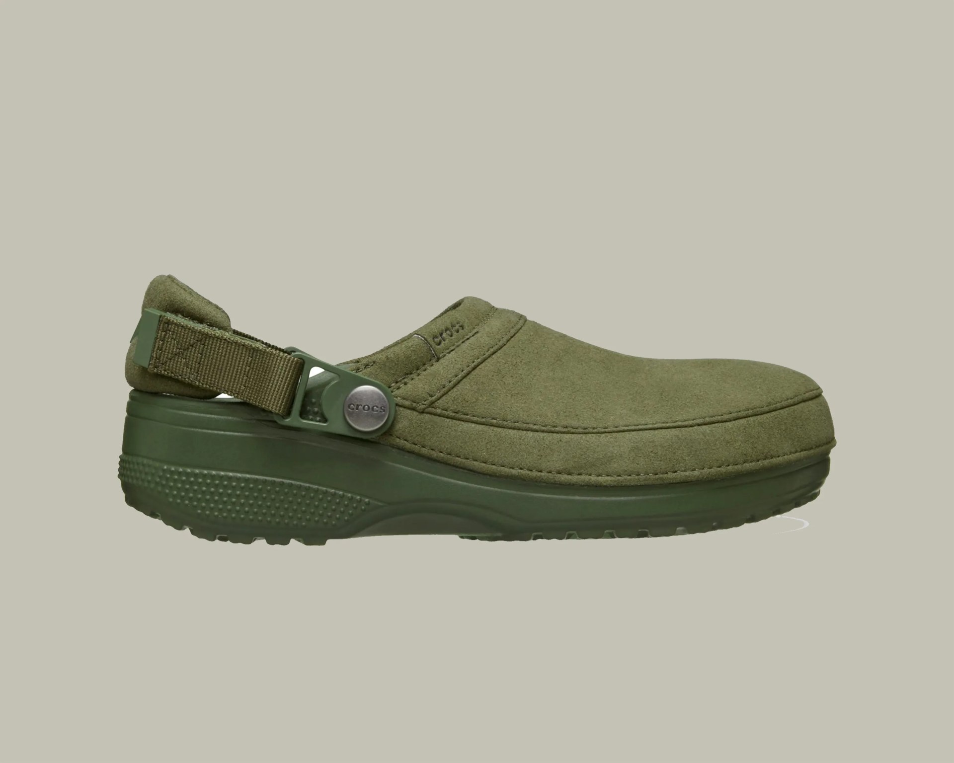 Olive green suede Crocs clog with adjustable heel strap and textured rubber sole.