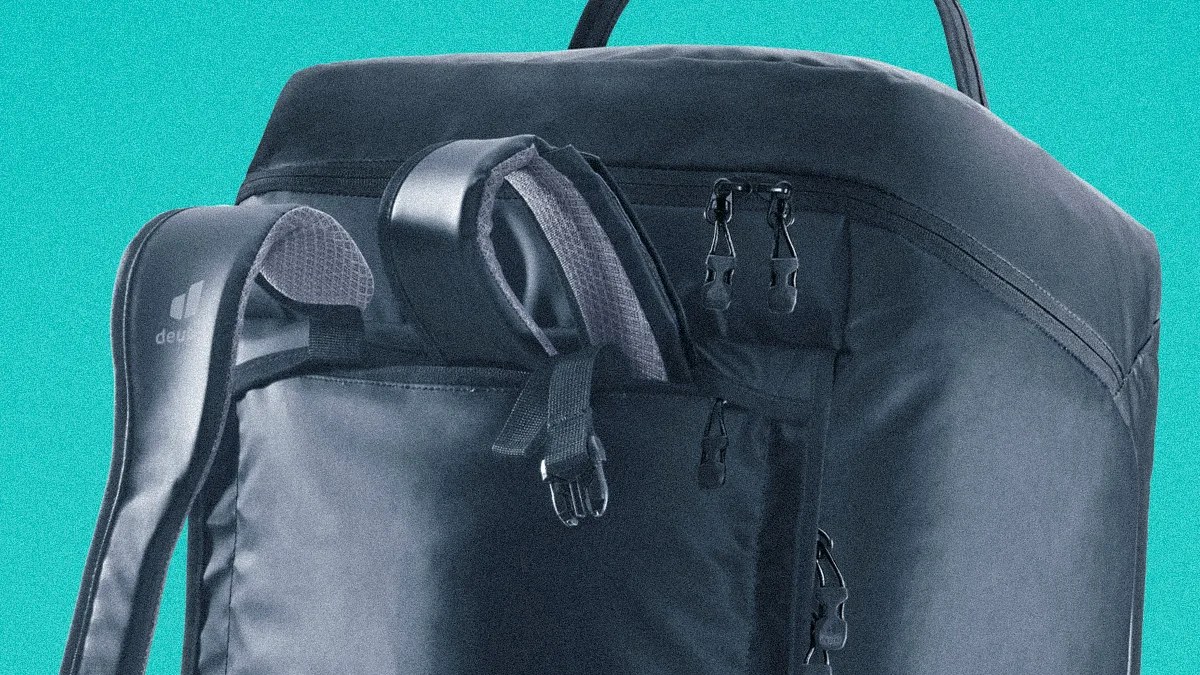 Black Deuter backpack with padded shoulder straps and multiple zipper compartments against a teal background.