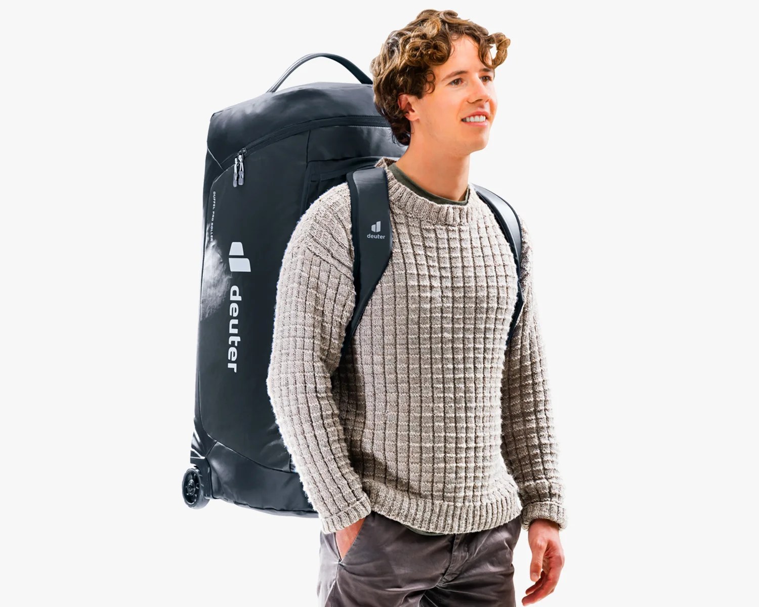 Man wearing a large black Deuter wheeled backpack with padded shoulder straps and a beige knit sweater.