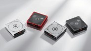 Four square portable CD players in white, red, silver, and black with digital displays on a reflective surface.