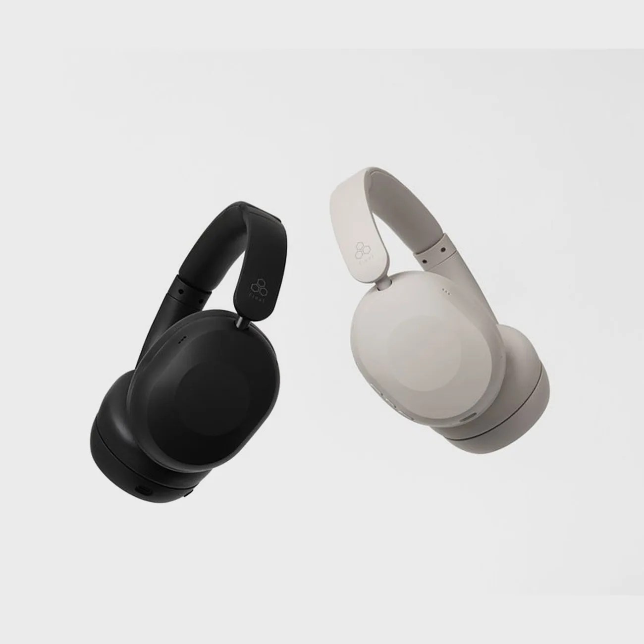 Pair of over-ear wireless headphones, one black and one light gray, with padded headbands and ear cups.