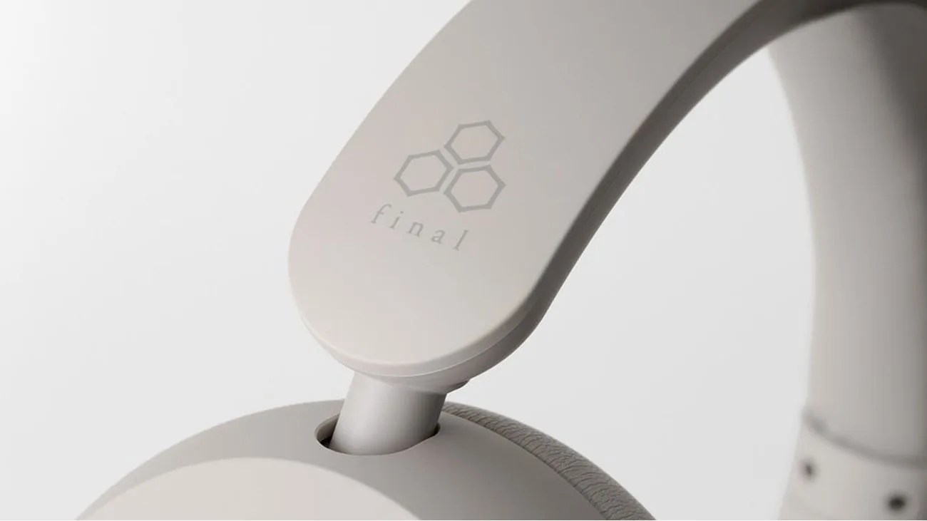 Close-up of light gray headphone arm with "final" logo and hexagonal design.