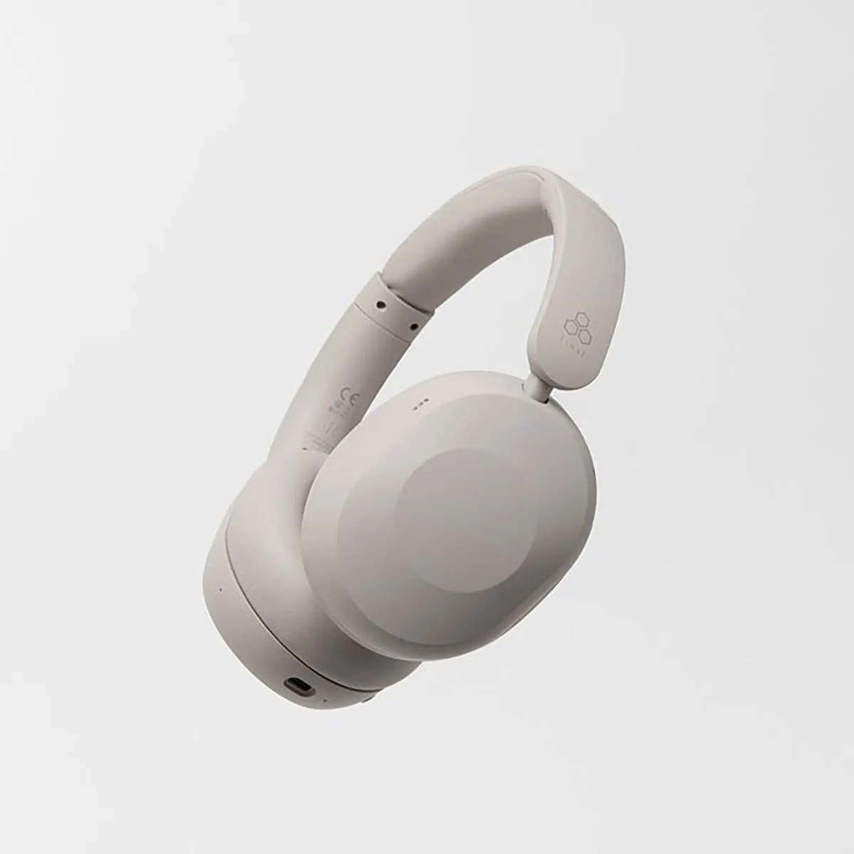 Light gray over-ear wireless headphones with padded headband and USB-C charging port.