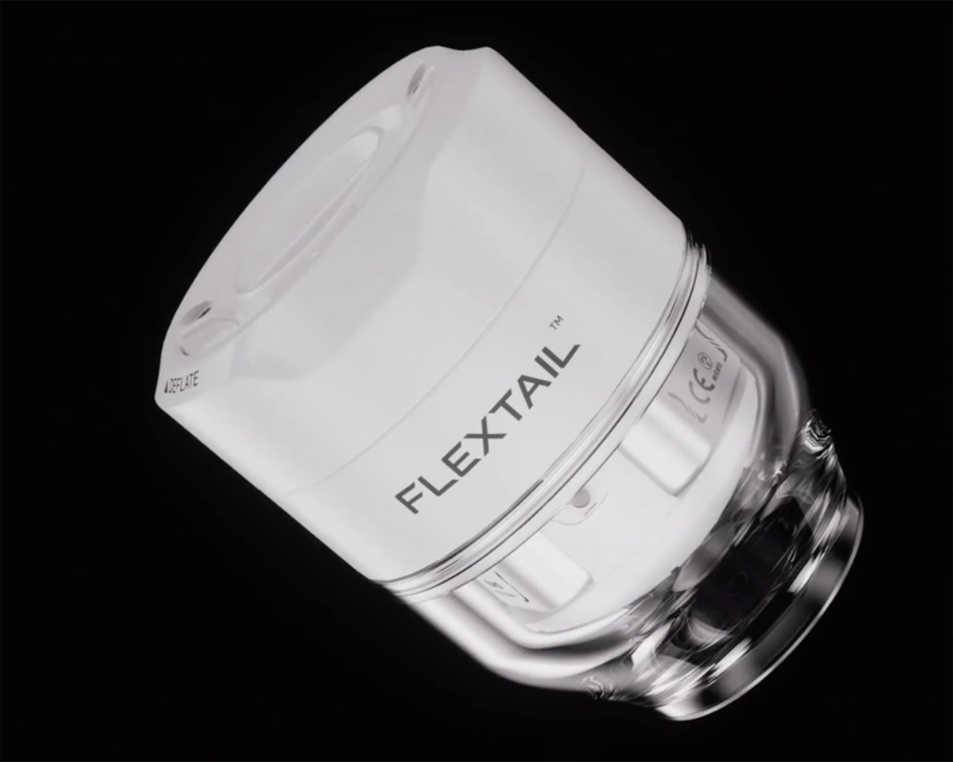 White and transparent cylindrical device labeled "FLEXTAIL" on a black background.
